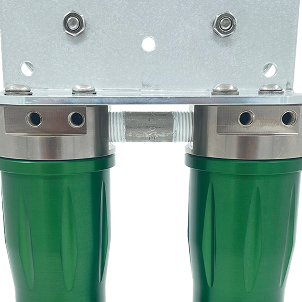stainless steel pipe connecting two green anodized aluminum housings bolted to a bracket